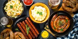 دانلود عکس استوک غذای Oktoberfest - سوسیس، آبجو و برتزل
