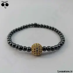 دستبند حدید دودی ریز و مهره نگین دار طلایی