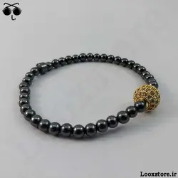 دستبند حدید دودی ریز و مهره نگین دار طلایی