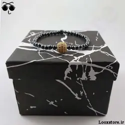 دستبند حدید دودی ریز و مهره نگین دار طلایی