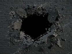 عکس با کیفیت تبلیغاتی دیوار سیاه تخریب شده با گوی تخریب