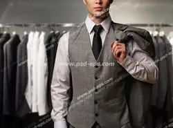 عکس با کیفیت مدل مرد با کت ، جلیقه و شلوار توسی با زمینه رگال لباس های متنوع