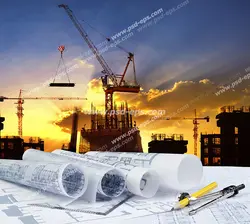 عکس با کیفیت نقشه ها و پلان های ساختمان سازی با پس زمینه ساختمان های در حال ساخت به همراه تاور کرین