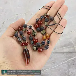 گردنبند مهره لول عقیق سلیمانی تبتی تراش شاخ با نقوش خاص، عقیق سرخ، لارویکیت، لاوا و صدف مشکی معدنی بافت گره ای