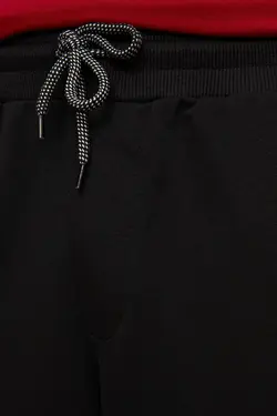 شلوار راحتی متناسب خط‎دار پاچه لاستیک مردانه مشکی برند TRENDYOL MAN کد 1651058625