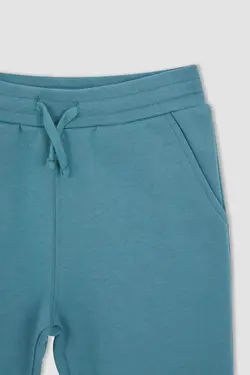 شلوار راحتی جاگر پسرانه فیروزه ای دفاکتو