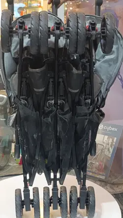 کالسکه دوقلو عصایی بغل هم رنگ طوسی خاکی بیبی کر با گارد محافظ جلو کالسکه  Baby Care Double Stroller