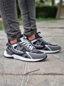 فروش ویژه کفش کتونی اسپرت مردانه مدل نیوبالانس فوق العاده جذاب و مدرن مشکی طوسی خط سفید