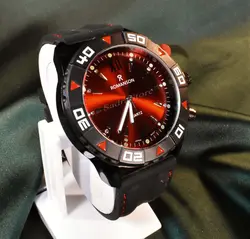 ROMANSON WATCH رومانسون تک موتوره نگین دار با صفحه زرشکی براق ** شیشه شفاف بندژله ای دور دوخت با صفحه ای ساده