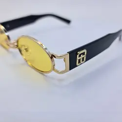 خرید عینک شب جنتل مانستر با فریم طلایی، بیضی شکل و دسته مشکی و لنز زرد مدل B2069 | فروشگاه آرکوشاپ