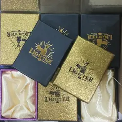 خرید عمده جعبه فندک طلایی مشکی بسته 12 عددی - استوریکس