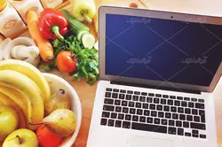 موکاپ لبتاب و دفترچه روی میز و پس زمینه آشپزخانه